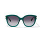 Intrigue Emerald Sunglasses with dark gradient lenses, featuring white decorative elements with gold accents on the temples, positioned against a plain white background.