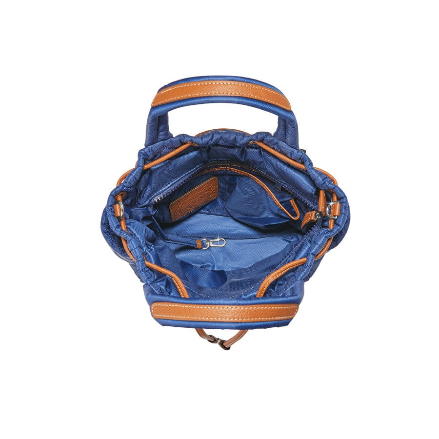 Inside view of a Blue Kenny Convertible Backpack with tan trim shows its interior, featuring multiple zippered compartments and pockets, set against a plain white background.