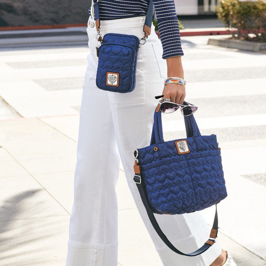 Kora Mini Utility Bag in blue worn by a model, demonstrating the size and stylish look