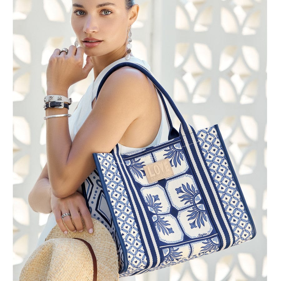 Model looking at camera with Lovely Tiles Canvas Carry All on shoulder