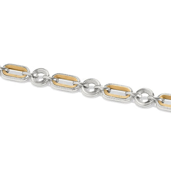 A silver and gold bracelet the Medici Two Tone Link Bracelet is composed of interlinked oval-shaped rings, varying in texture, against a white background.