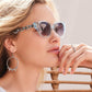 Woman wearing Twinkle Chain Sunglasses with matching earrings looking to the right