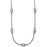 The Illumina Petite Collar Necklace a silver chain necklace with evenly spaced, encased diamond-like stones, displayed against a white background.