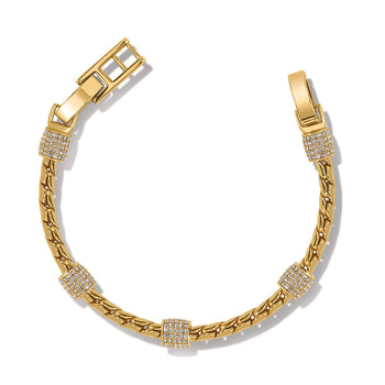 A Meridian Bracelet with gold showcases a twisted rope design, punctuated by sparkling encrusted accents, displayed against a plain background.