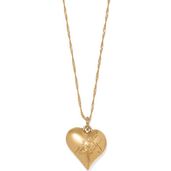 The Trust Your Journey Golden Heart Necklace with a gold heart-shaped pendant hangs on a twisted chain, with the inscription "Thank you for being a friend". The background is plain and white.